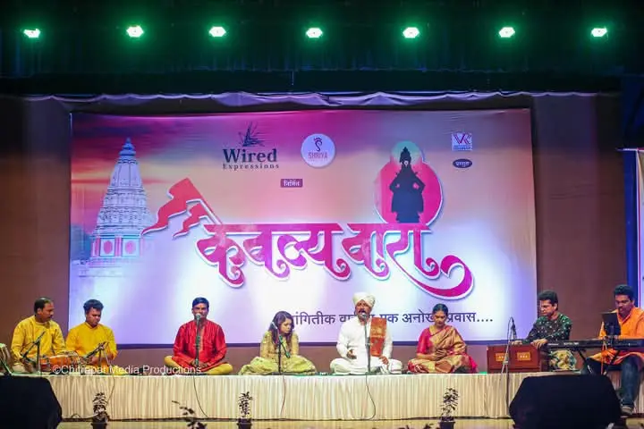 Musicians on stage beneath the KaivalyaVaari banner in Dombivli